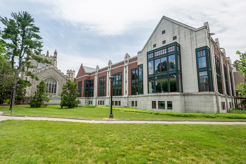 A building with a lawn and a lamp post.