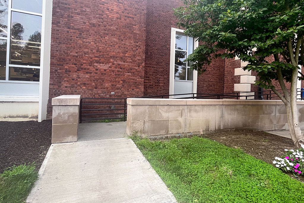 A brick building with a ramp leading to a building.