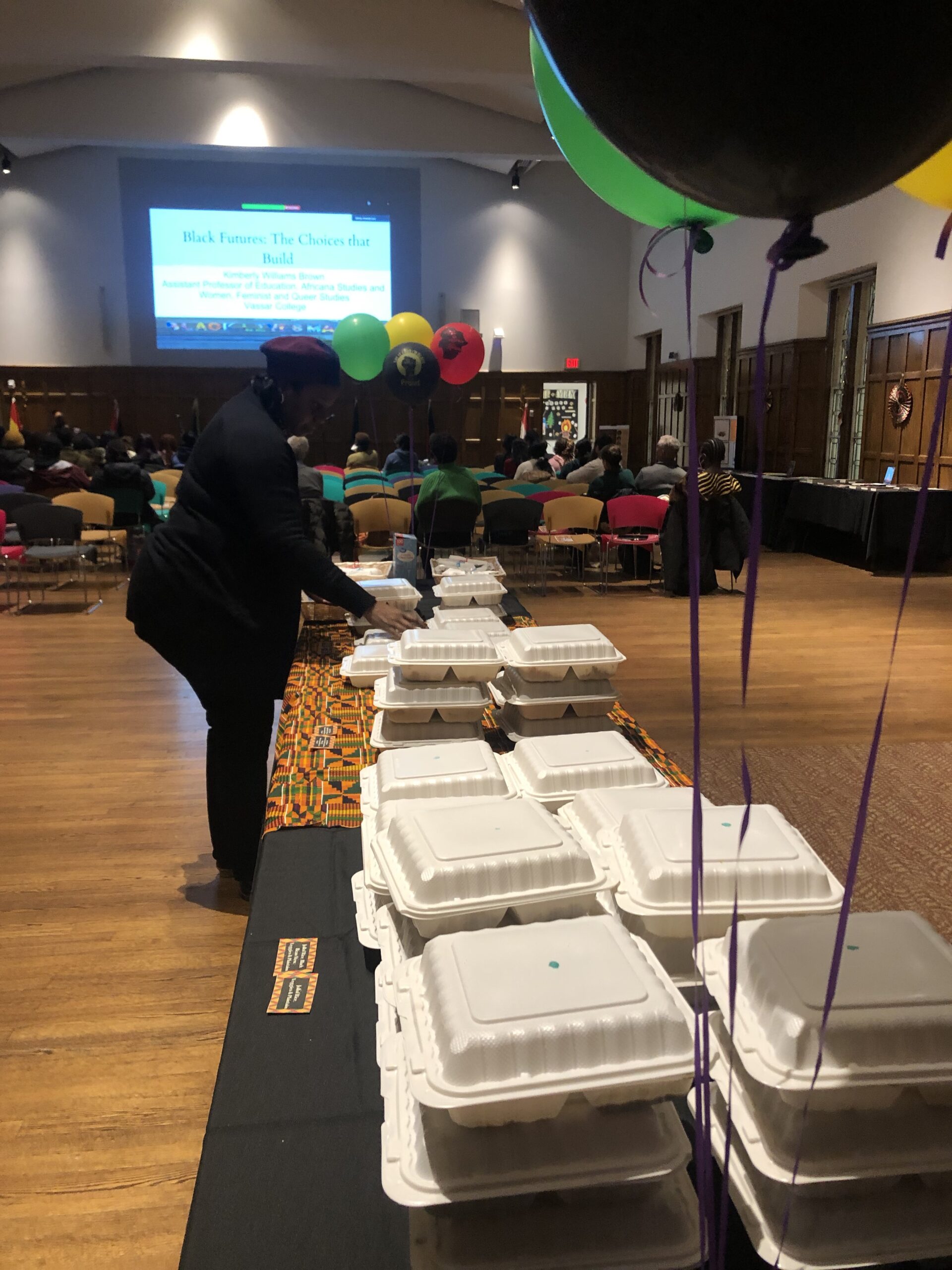 Nicole Beveridge, Jeh V. Johnson ALANA Cultural Center Director arranging the individually packaged food catered from N & J Catering. 