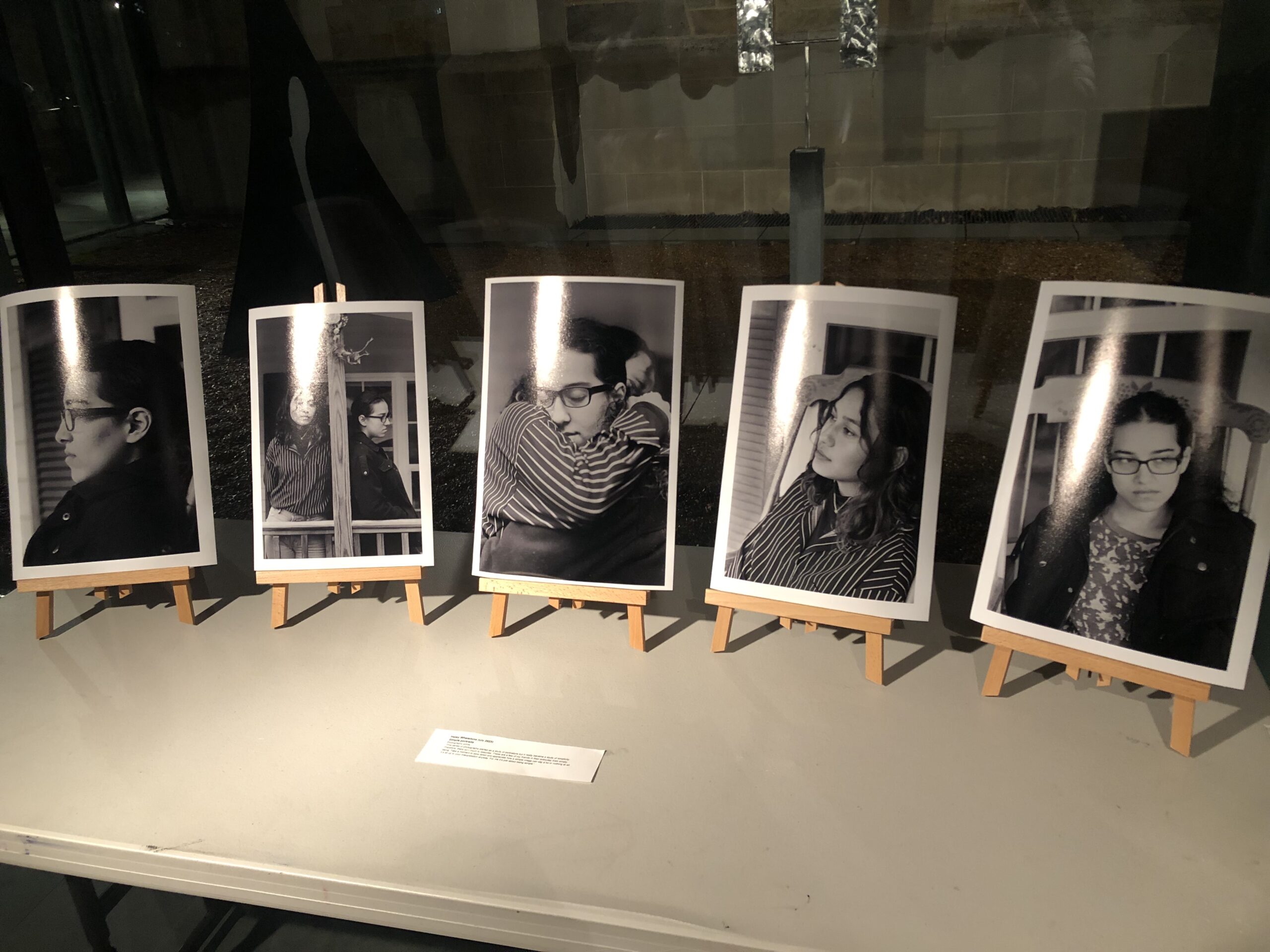 Five black and white photos on small wooden easels displayed on the table from photographer Haley Whetstone. 