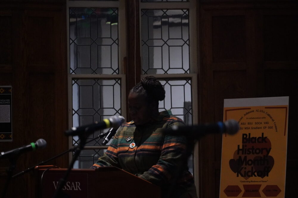 Dr. Nicole Beveridge, ALANA Director standing at the podium speaking into the mic. 