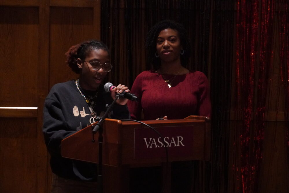 Mariah Jones and Marissa Desir standing at the podium. Mariah is talking into the mic and Marissa is standing to the right. 