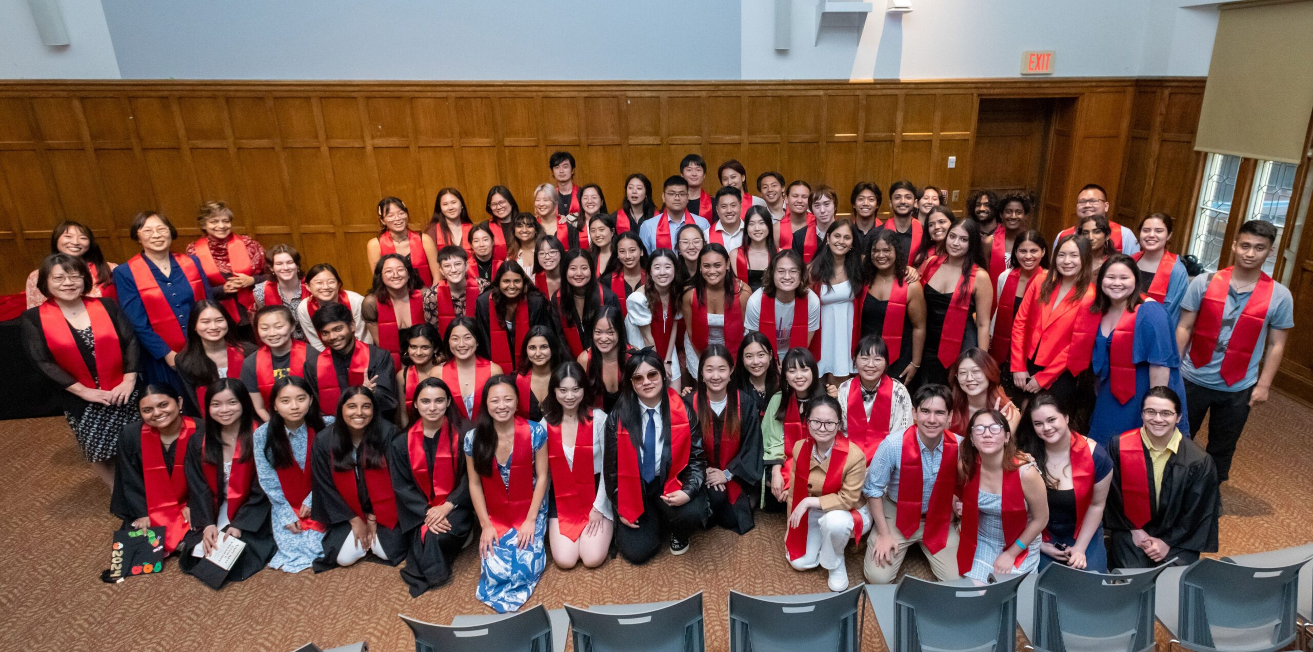 Group photo with students, faculty and alum after the red graduation stoles were distributed in the Villard room. 