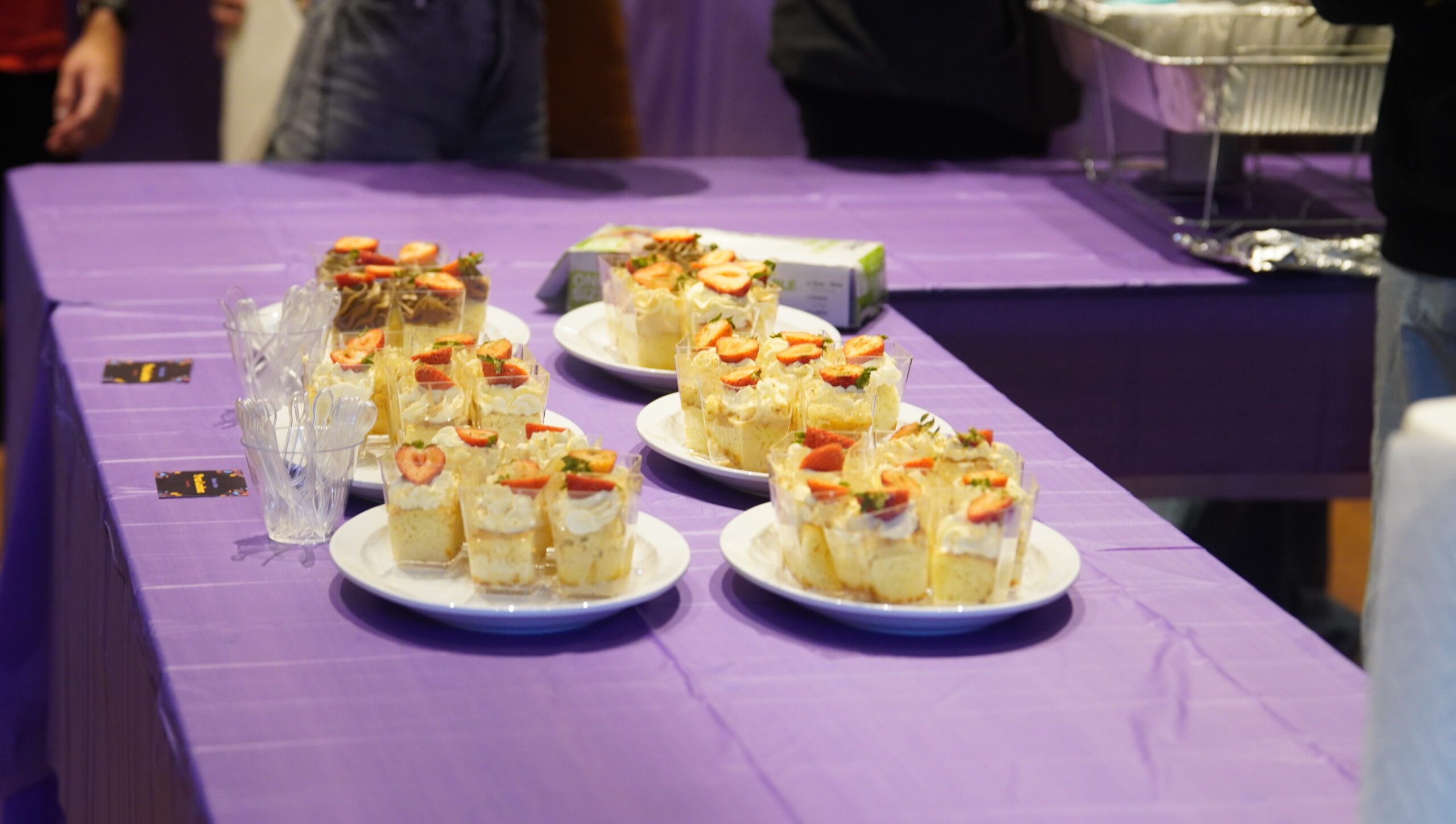 Photo of six white plates filled with tres leche desserts.