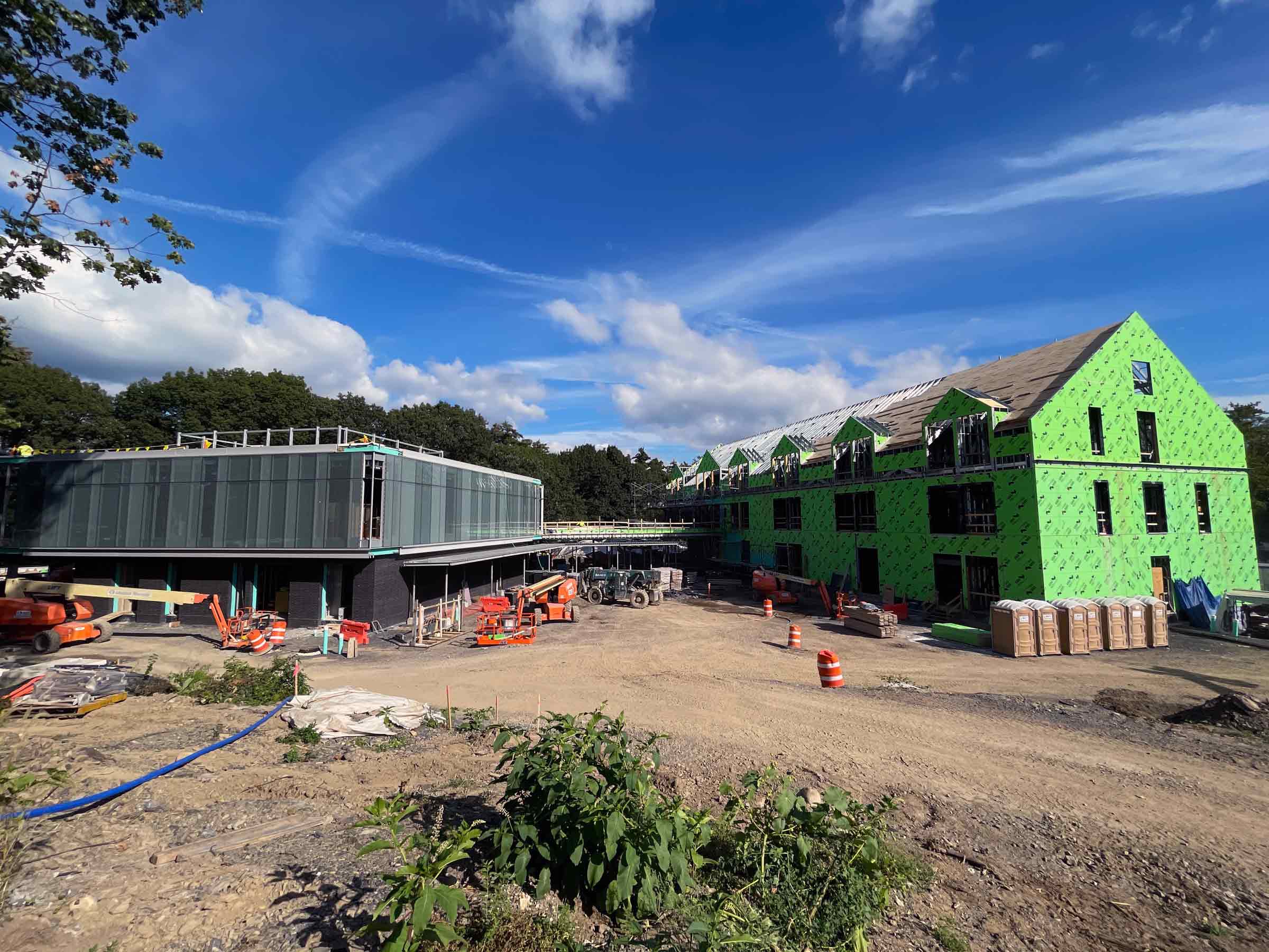 Construction site with two buildings in various states of completion