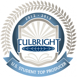 Official badge featuring the Fulbright Program logo inside a shield with rays of light and an open book, encircled by laurel leaves. The top reads '2012–2013' and a blue ribbon below states 'U.S. Student Top Producer'.