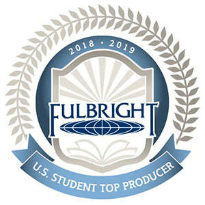 Official badge featuring the Fulbright Program logo inside a shield with rays of light and an open book, encircled by laurel leaves. The top reads '2018–2019' and a blue ribbon below states 'U.S. Student Top Producer'.