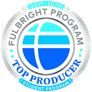 Official badge for the Fulbright Program’s 2019–2020 Student Program Top Producer, featuring a stylized blue and white globe with the number 75, encircled by laurel leaves and text in silver, blue, and teal.