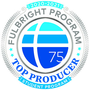 Official badge for the Fulbright Program’s 2020–2021 Student Program Top Producer, featuring a stylized blue and white globe with the number 75, encircled by laurel leaves and text in silver, blue, and teal.